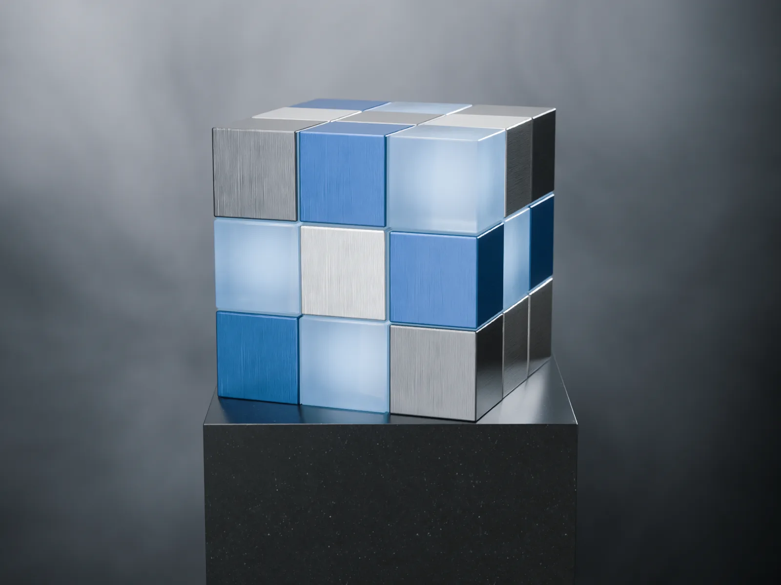 The solved cube at rest on a black stone plinth, in a dark studio.