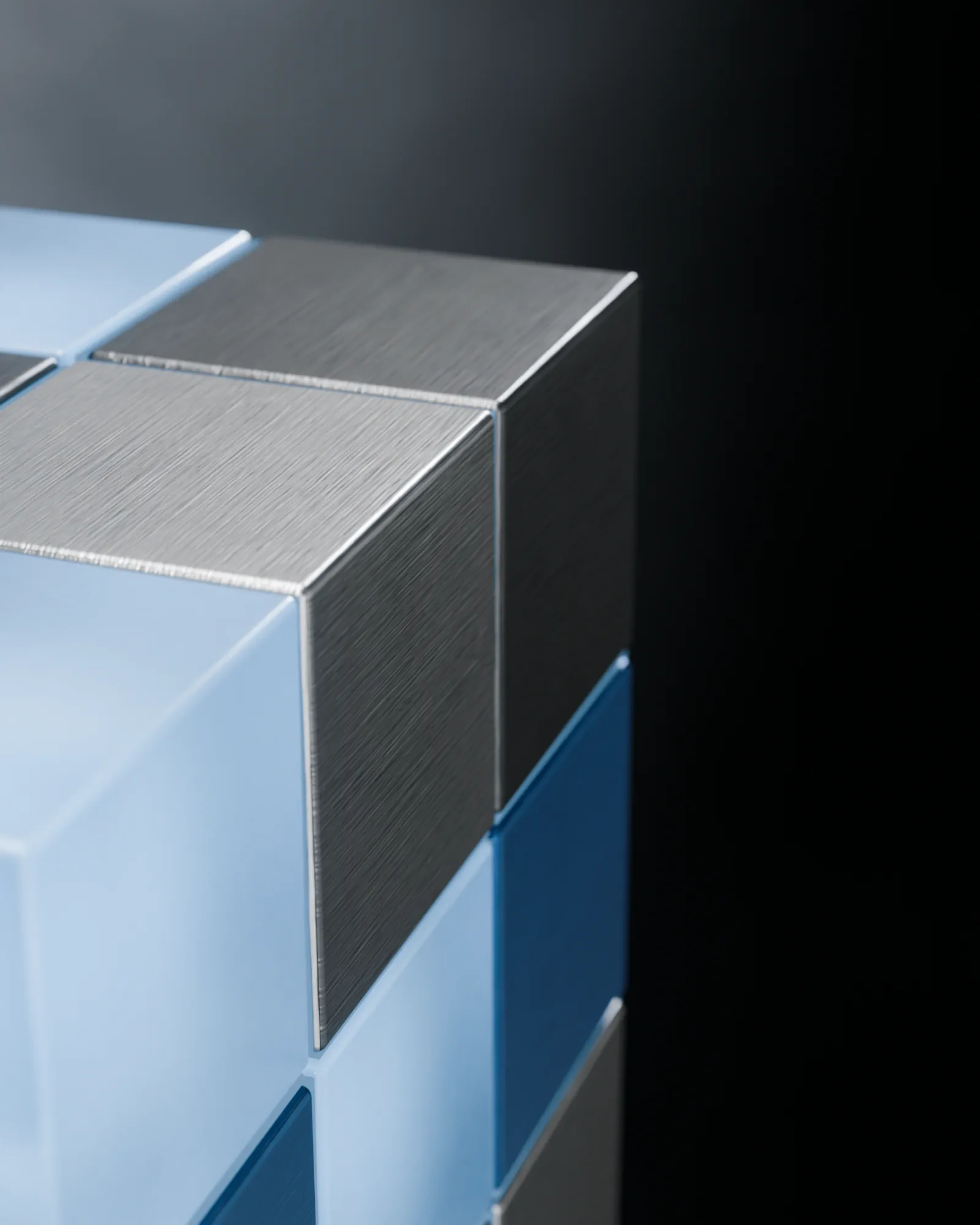 Frosted sky blue glass catching the key light, very close.