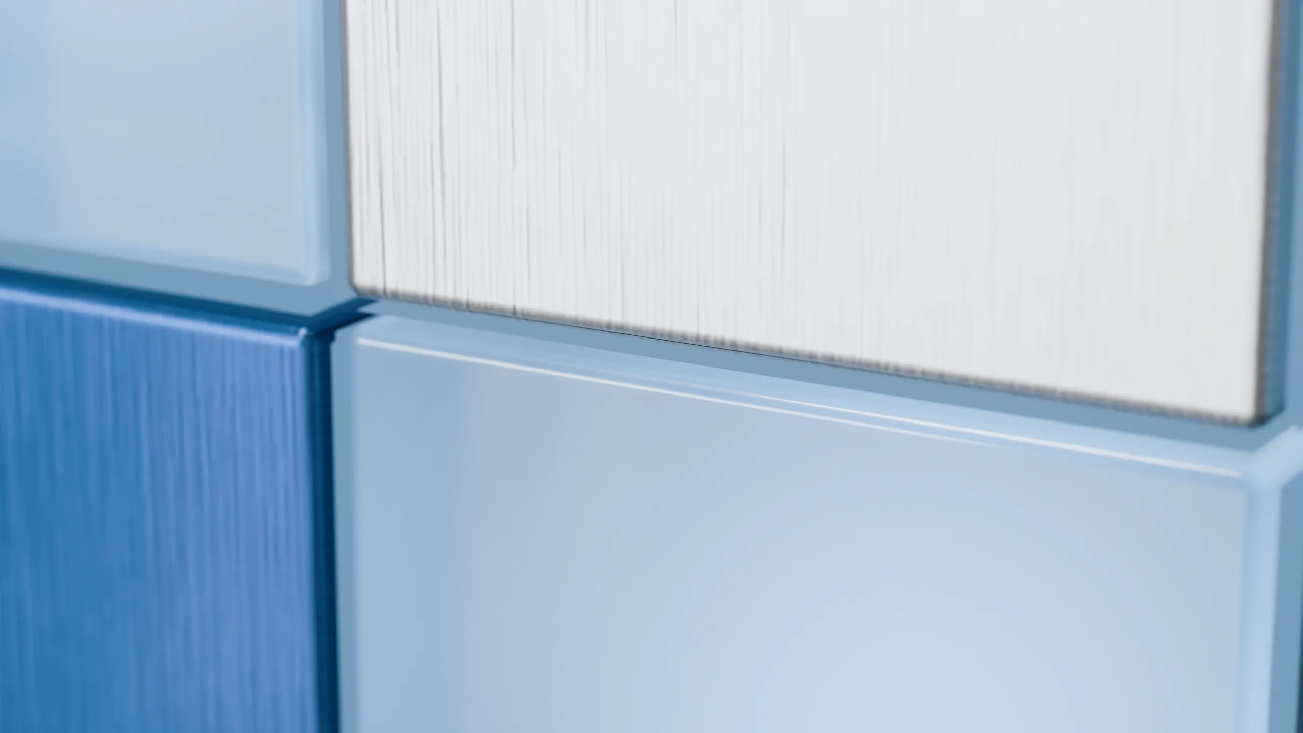 Close up of the cube's edge, where brushed aluminium meets frosted blue glass.